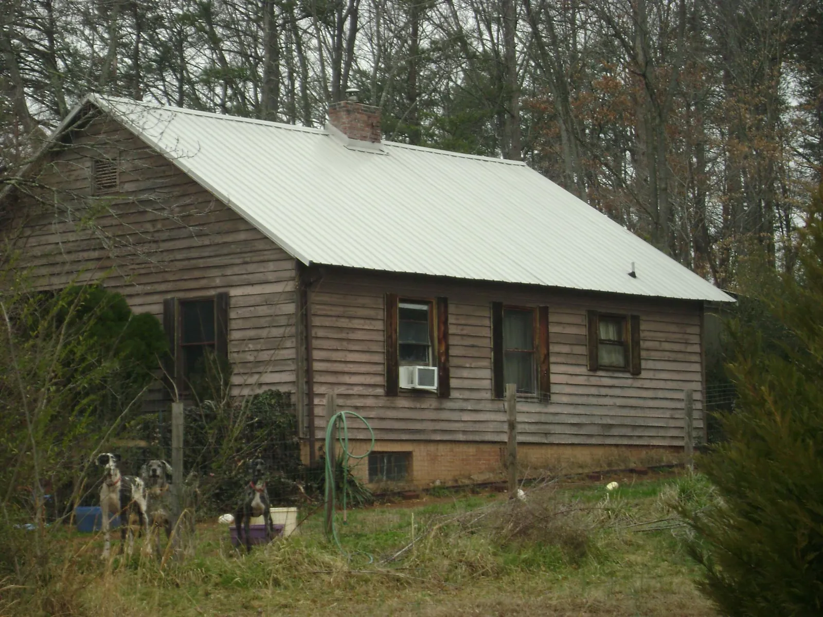 White metal roof on an old wood sided farmhouse, from a Metal Roof Installation job in Warwick